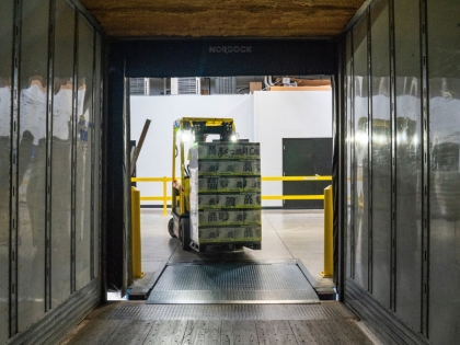 Forklift loading a shipping container