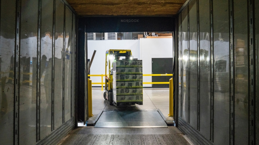 Forklift loading a shipping container